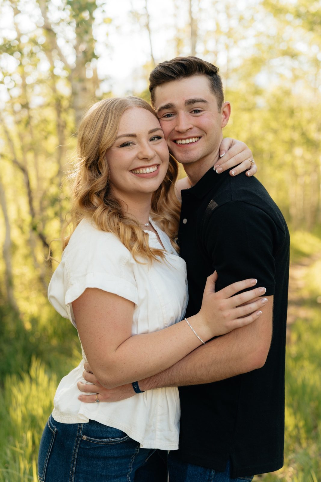 Grayce and Phillip smiling in the aspens